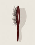 The Mini Bordeaux - A dark reddish-brown handle and silver bristles.