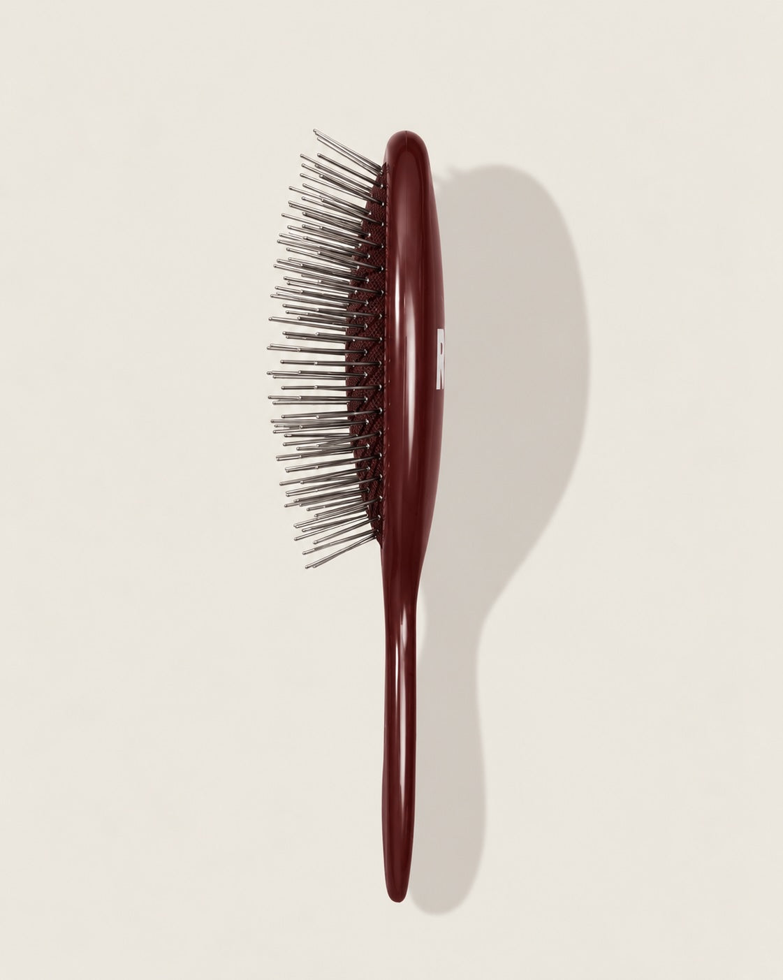 The Mini Bordeaux - A dark reddish-brown handle and silver bristles.