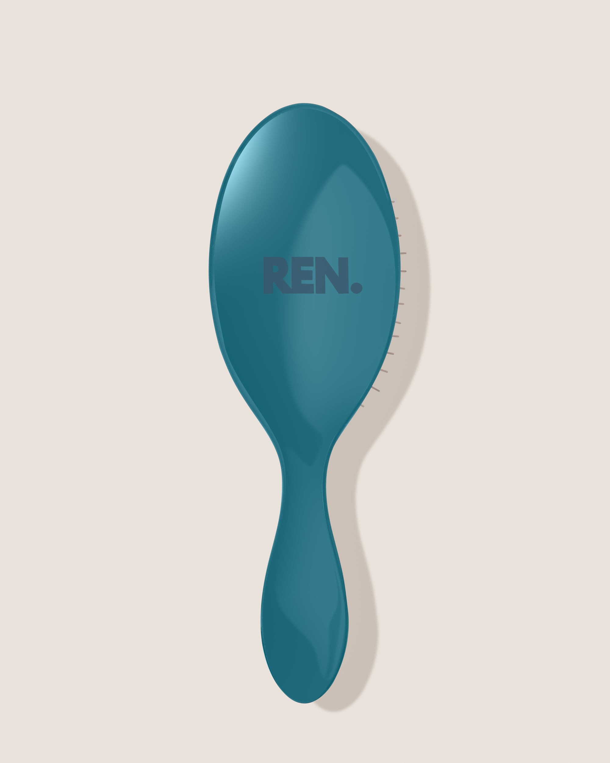 REN. Ultimate detangling brush in Turquoise