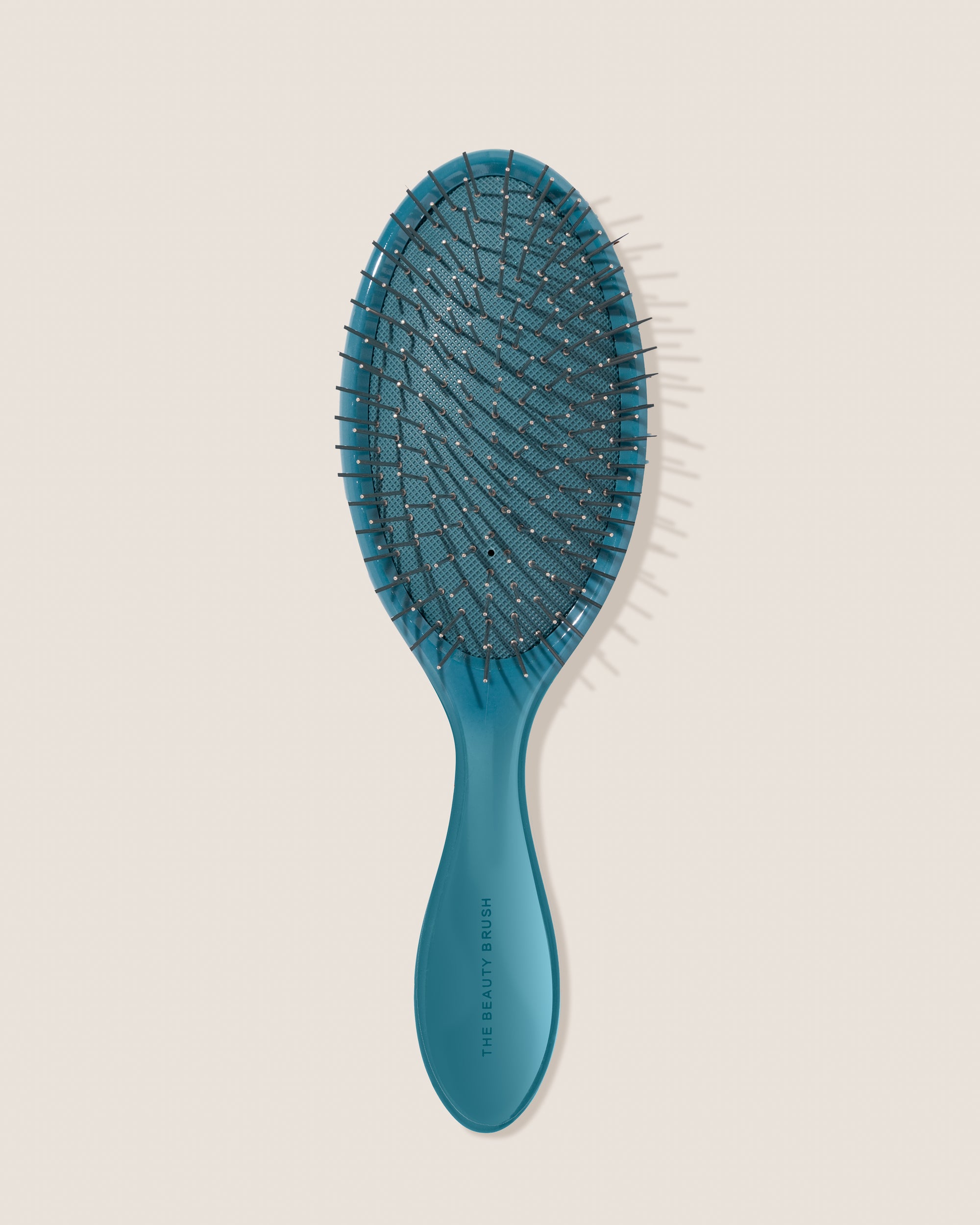 REN. Ultimate detangling brush in Turquoise